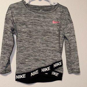 Nike 2T dri fit long sleeve gray shirt with black trim and a pink check